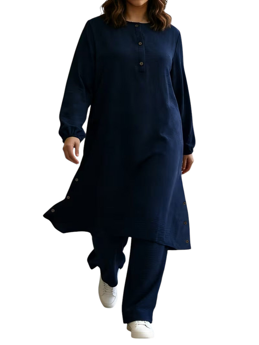 Linen & Loom navy blue long-sleeve abaya tunic with wooden buttons and matching wide-leg pants on a model.