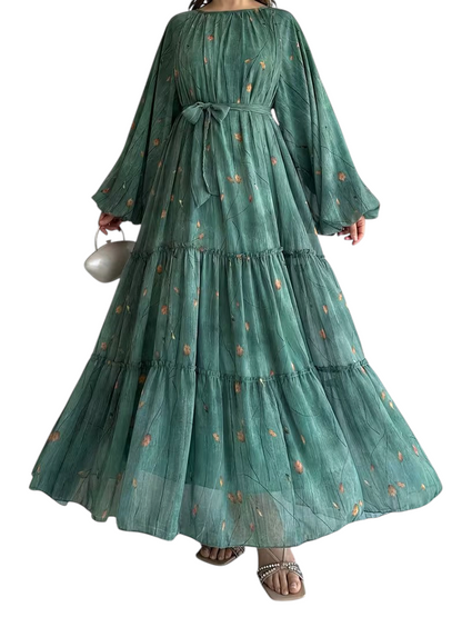 Linen & Loom chiffon abaya dress in sage green with a delicate floral print, tiered skirt, and matching waist belt.