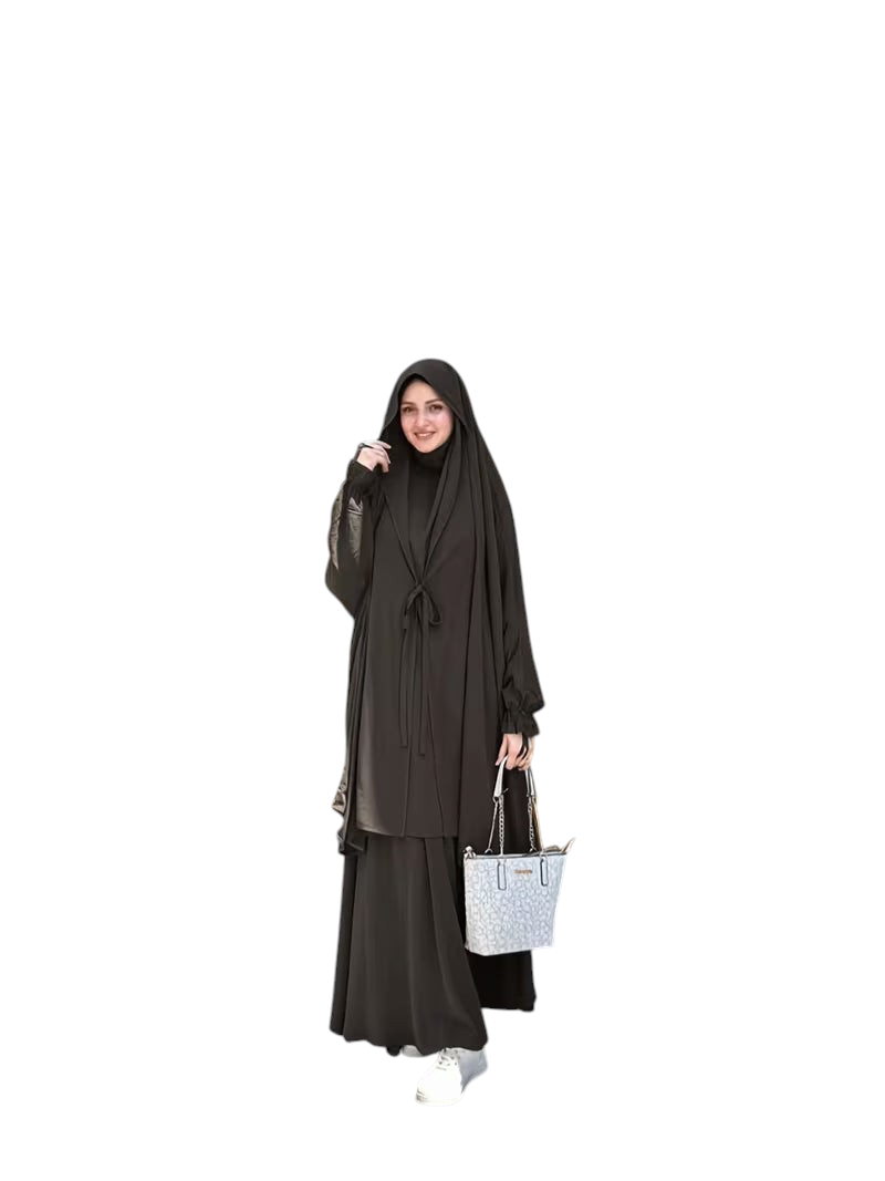Linen & Loom black Arabic-style abaya set with lace-up detail and matching headscarf worn by a woman outdoors.