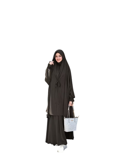 Linen & Loom black Arabic-style abaya set with lace-up detail and matching headscarf worn by a woman outdoors.