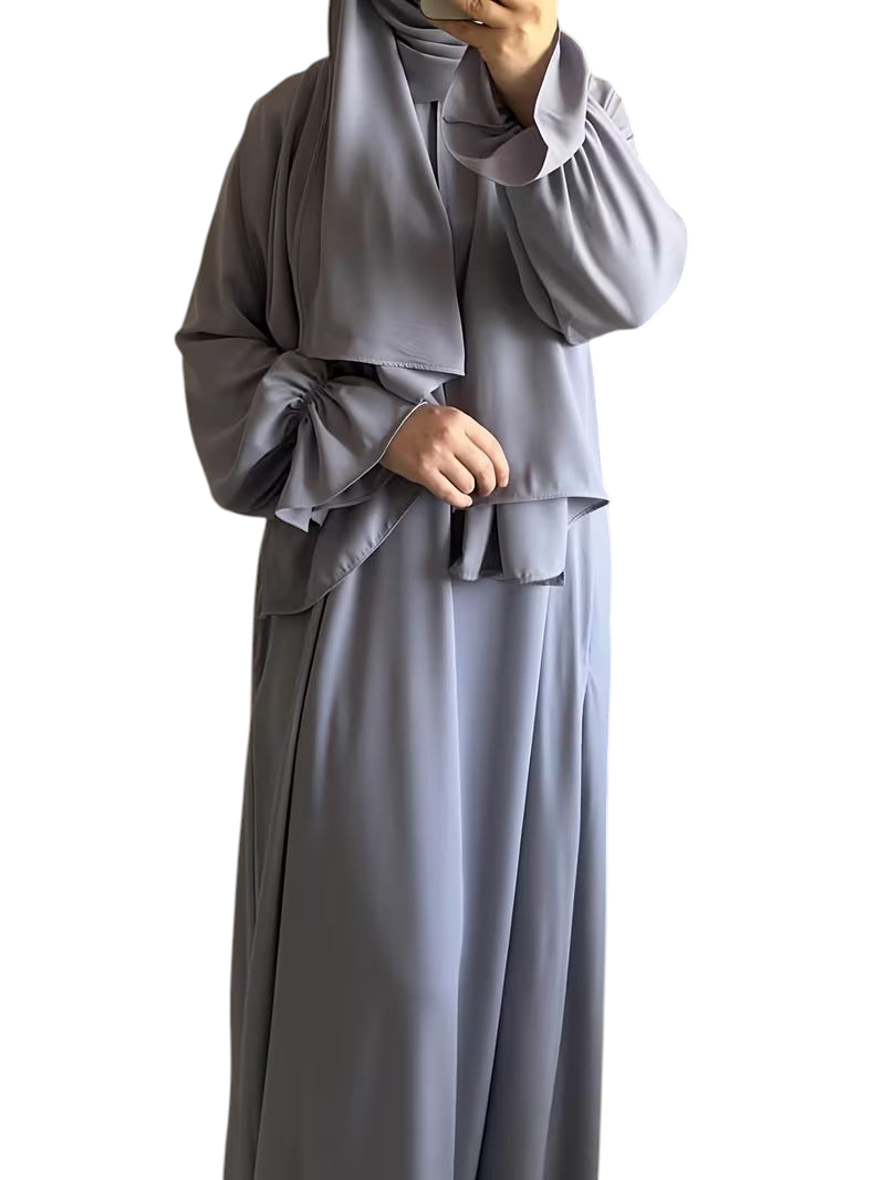 Linen & Loom elegant grey one-piece abaya with bell sleeves and a matching hijab in a modest flowing silhouette.