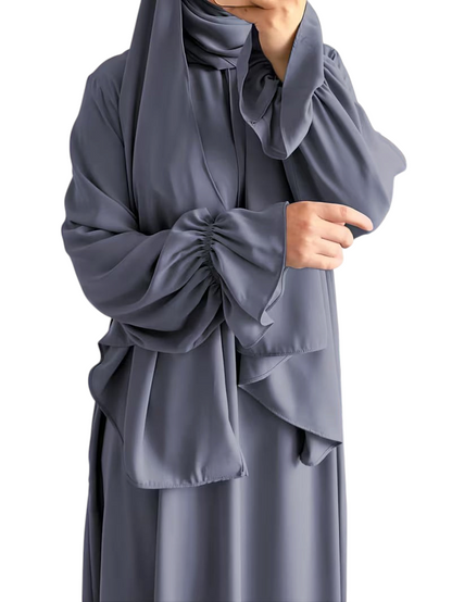 Linen & Loom elegant grey one-piece abaya with flowing bell sleeves and matching hijab in a modest, comfortable style.