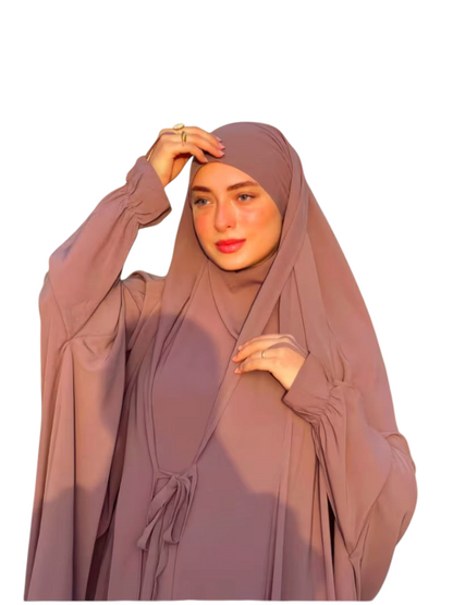 Linen & Loom mauve Arabic-style abaya set with lace-up detail and matching headscarf worn by a woman outdoors.