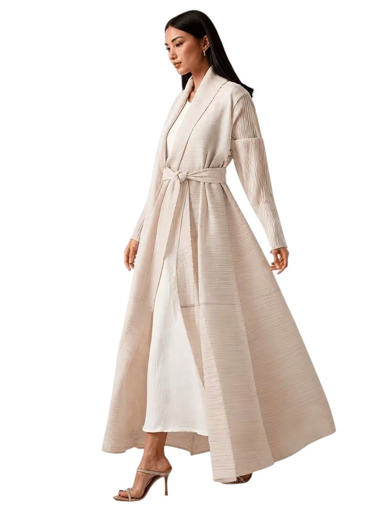 Linen & Loom elegant beige pleated cape abaya with a tie waist, worn by a model in a modest flowing silhouette.