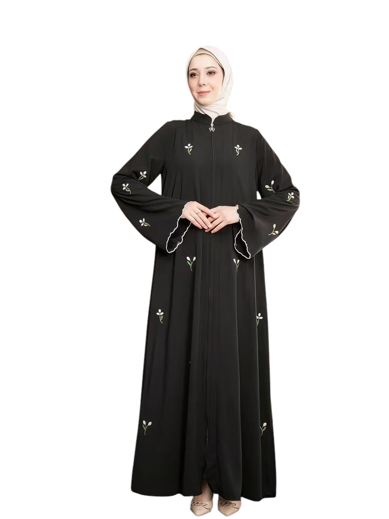 Linen & Loom black full-length abaya featuring delicate white floral embroidery, front zipper, and flared sleeves.