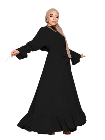 Linen & Loom black chiffon long abaya dress with ruffled sleeves and hem worn by a model on a staircase