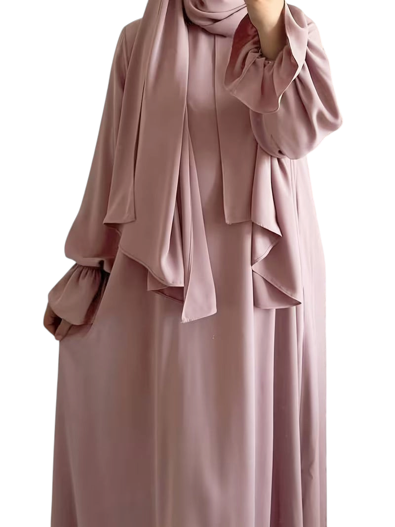 Linen & Loom elegant dusty pink one-piece abaya with flowing bell sleeves and matching hijab in a modest design.