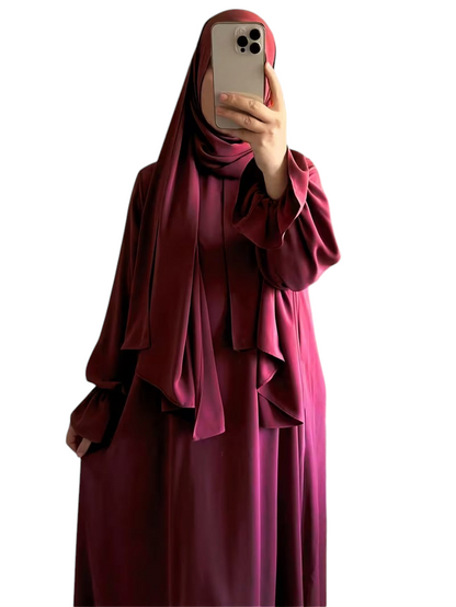 Linen & Loom elegant burgundy one-piece abaya with flowing bell sleeves and matching hijab in a modest silhouette.