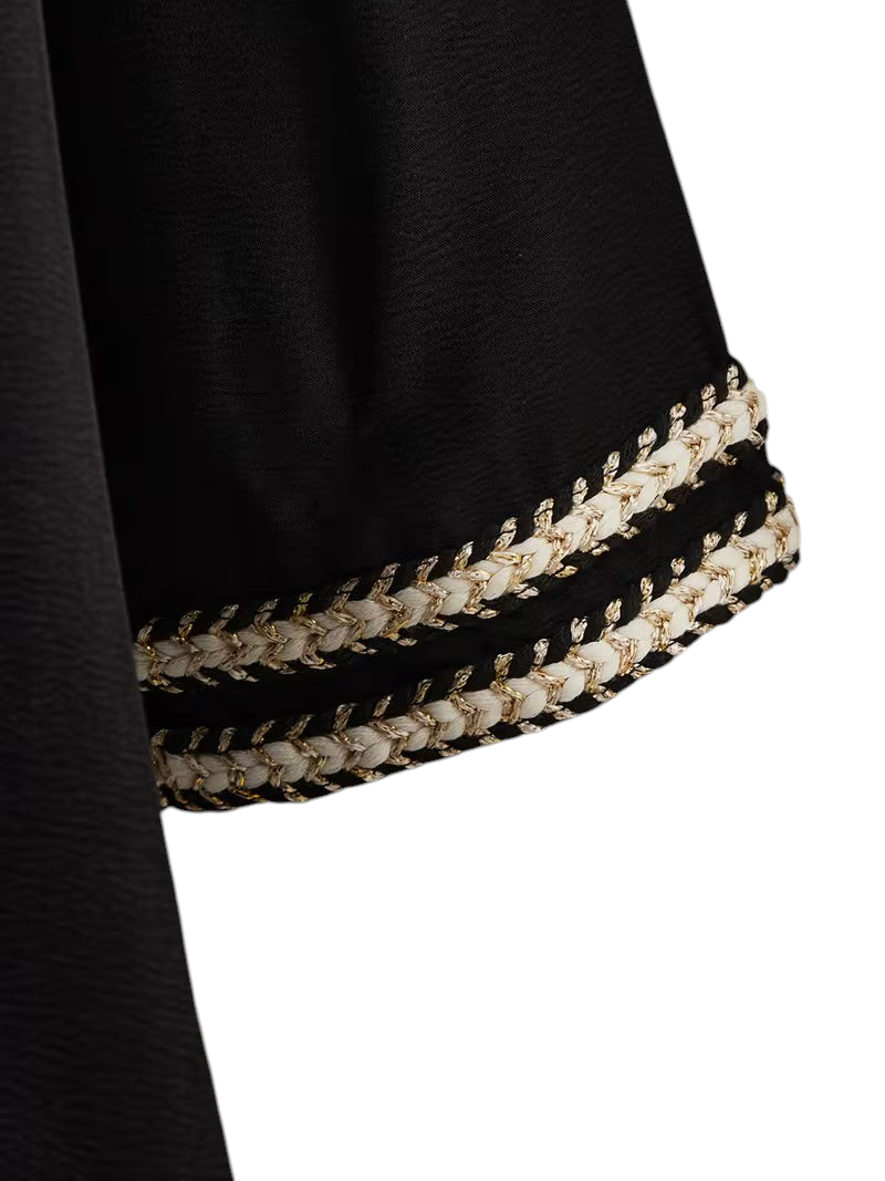 Linen & Loom black Arab-style daily dress sleeve featuring intricate cream and gold braided trim detail.