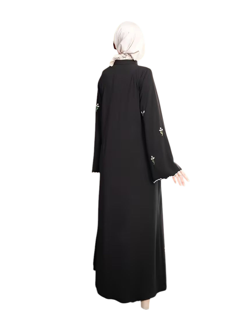 Linen & Loom black full-length abaya with delicate floral embroidery on sleeves and white scalloped trim details