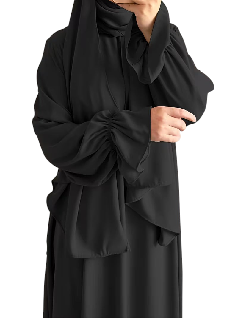 Linen & Loom black one-piece abaya with elegant bell sleeves and a flowing modest silhouette.