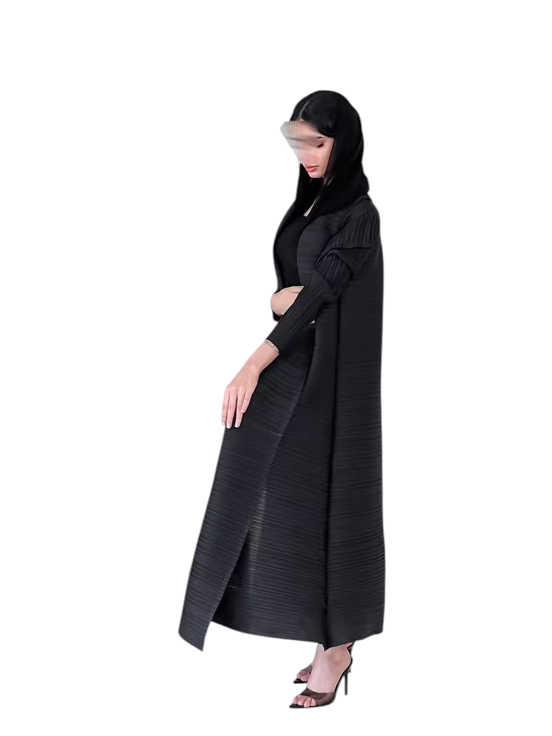 Linen & Loom black plisse abaya with long sleeves and loose fit, worn by a model in a minimalist interior.