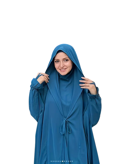 Linen & Loom blue Arabic-style abaya set with lace-up front detail and matching headscarf worn by a smiling woman