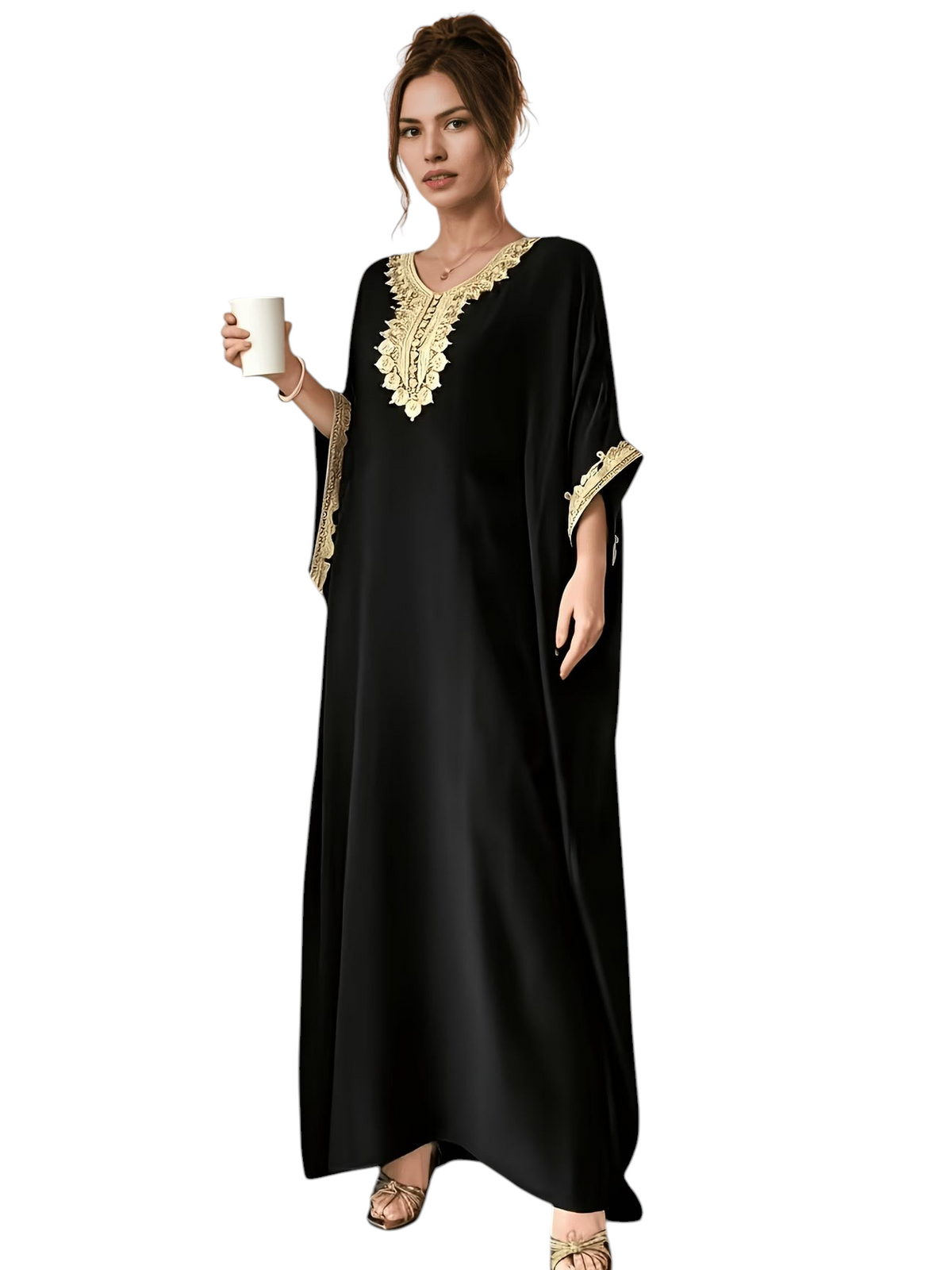Linen & Loom black batwing abaya with intricate golden embroidery on the neckline and cuffs, worn in a cafe setting.