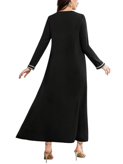 Linen & Loom black modest Arab-style daily dress with long sleeves and decorative white cuff detailing, back view