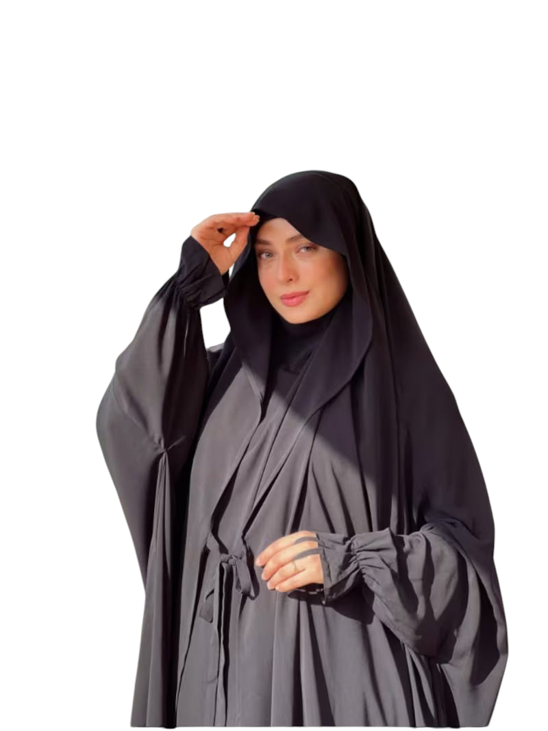 Linen & Loom black Arabic style abaya set with lace-up detail and matching headscarf worn by a woman outdoors