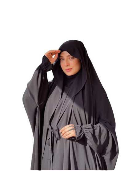 Linen & Loom black Arabic style abaya set with lace-up detail and matching headscarf worn by a woman outdoors