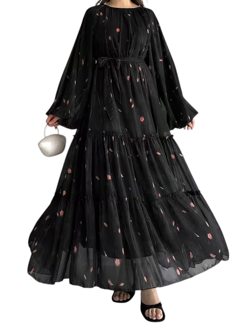 Linen & Loom black chiffon abaya dress with a floral print, long sleeves, tiered skirt, and a matching waist belt.