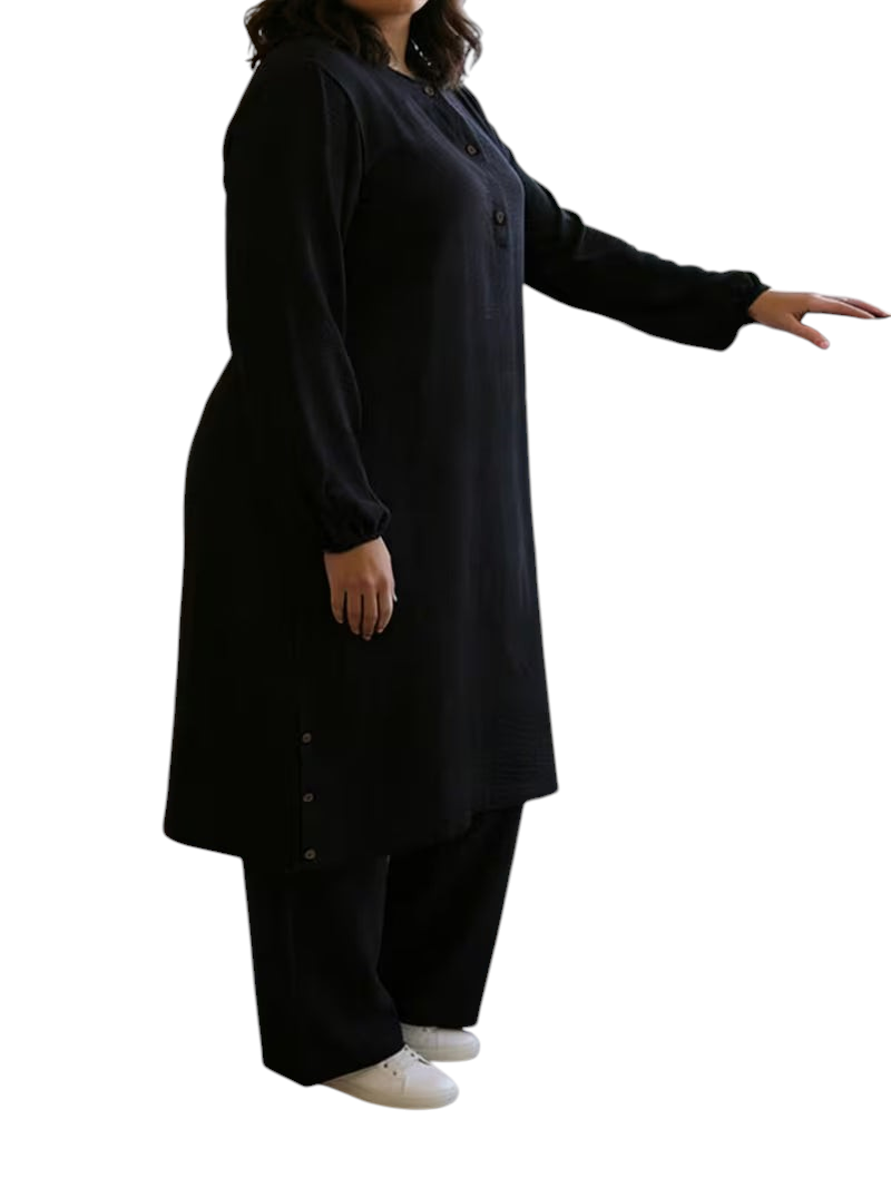 Linen & Loom black long-sleeve abaya tunic with wooden buttons and matching wide-leg pants, worn by a model.