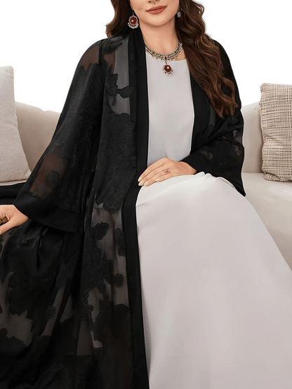 Linen & Loom plus size black chiffon jacquard abaya with long sleeves worn over a white dress in a bright room