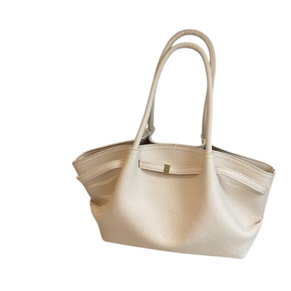 Linen & Loom creamy white leather tote handbag with double handles and a minimalist strap detail on a white surface.