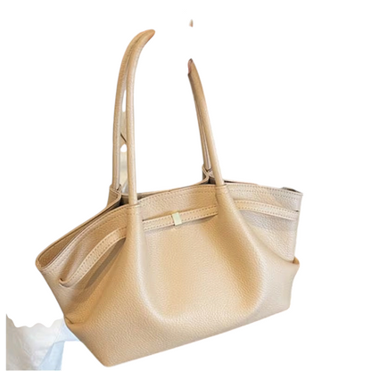 Linen & Loom creamy beige leather tote handbag with double handles held by a woman in a black blazer