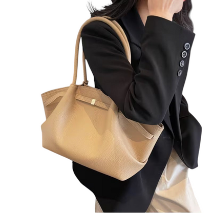 Linen & Loom creamy beige leather shoulder tote bag with double handles carried by a woman in a black blazer